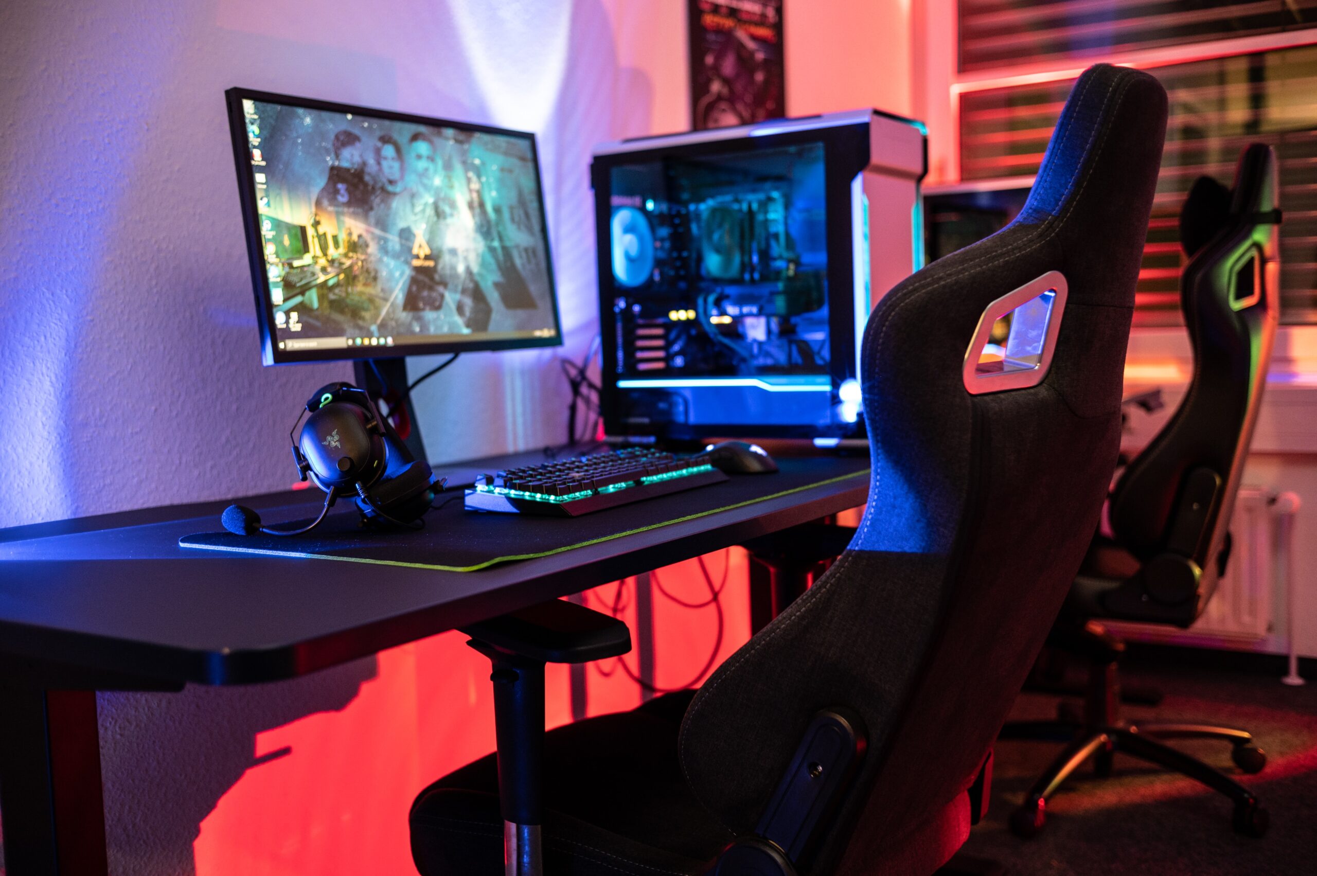 A brightly lit PC gaming setup with a comfortable chair, monitor, and desk